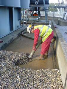 dry vac unit removing contaminated pebbles 